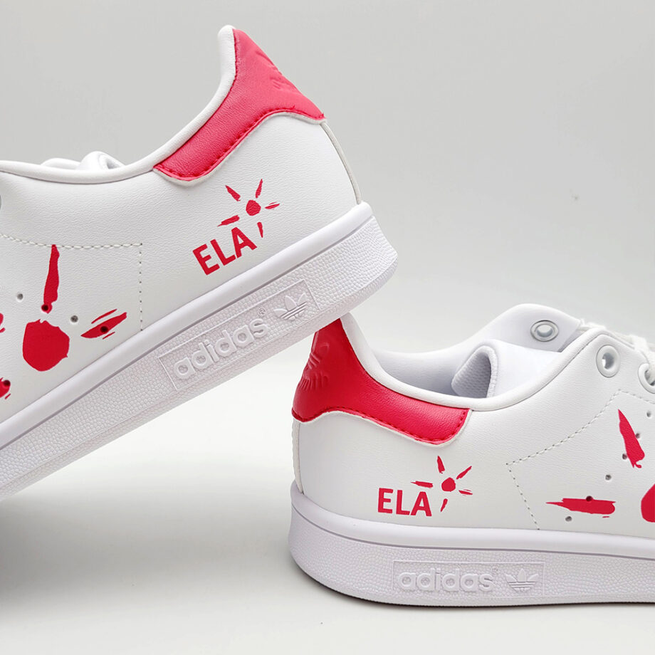 The ELA association logo and a big sun on Adidas Stan Smith sneakers