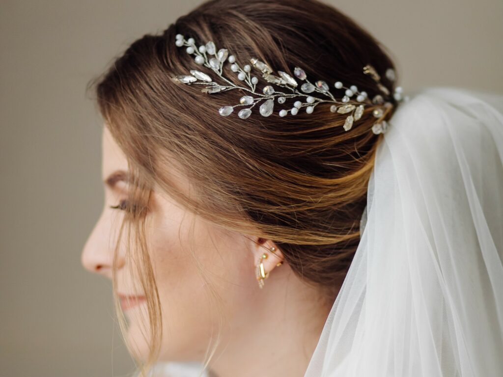 La coiffure de la mariée peut être agrémentée d'accessoire comme un voile, une couronne, une broche, etc.